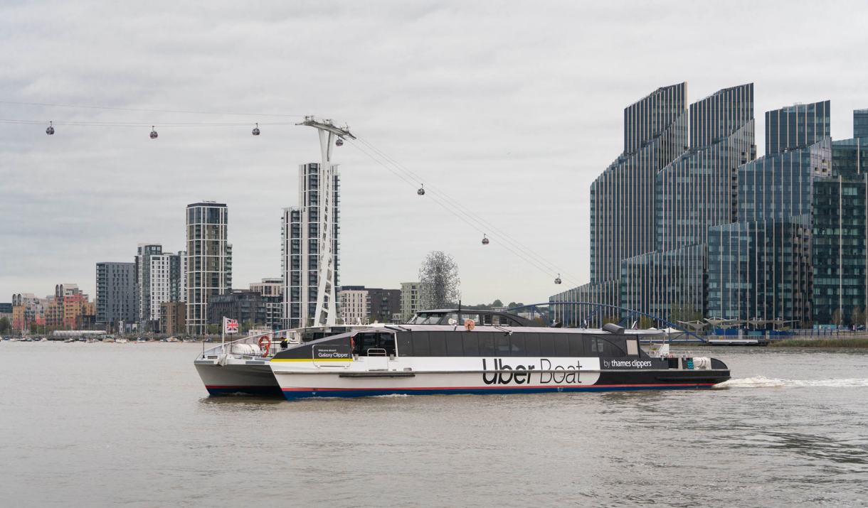 Uber Boat by Thames Clippers sailing past the Emirates Air Line in Greenwich